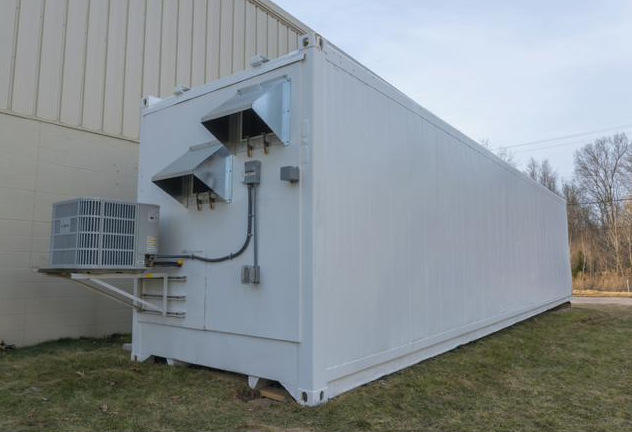 Exterior of a white 40-foot shipping container fitted with an HVAC unit, the MycoLogic Gen 3 Fruiting Module