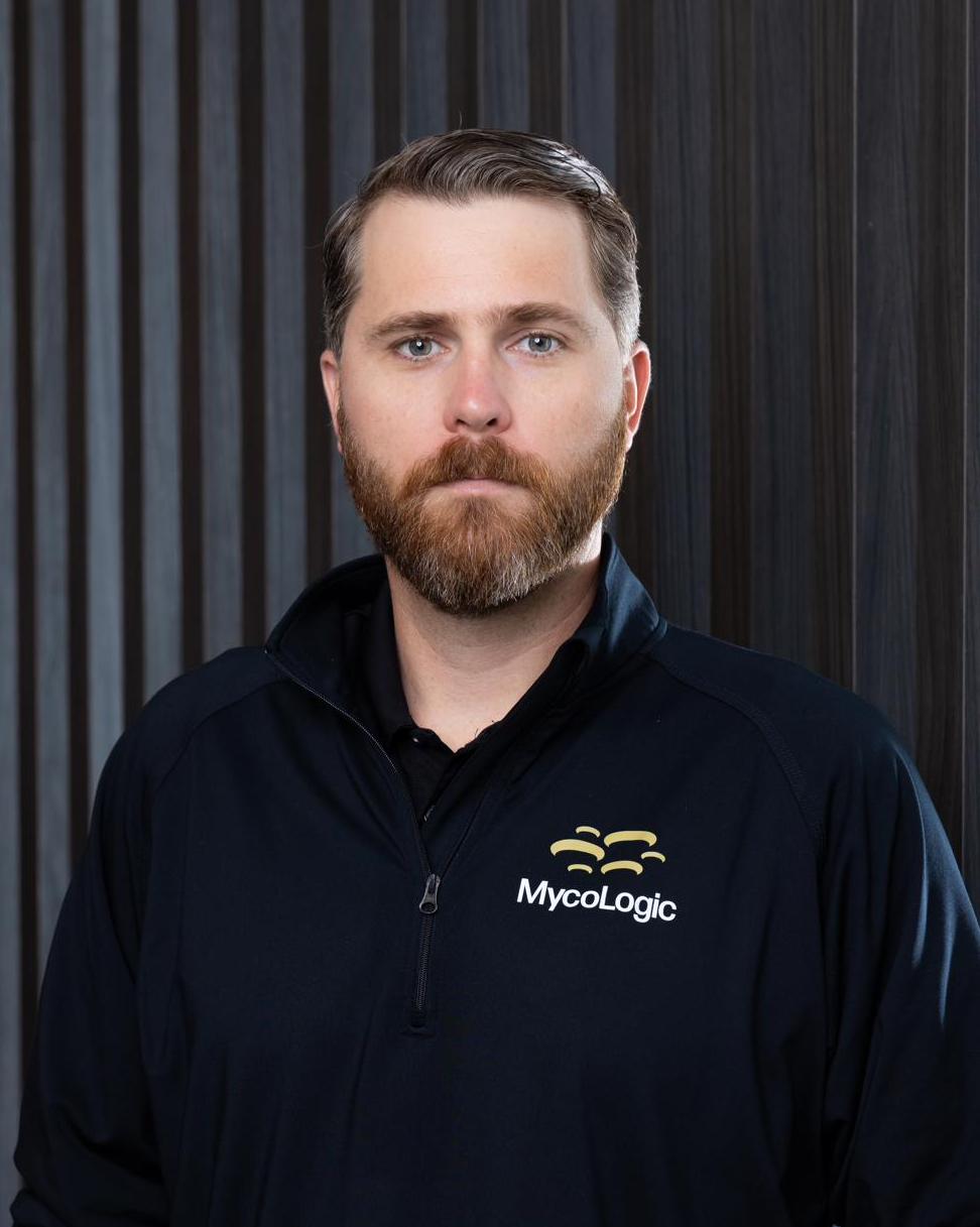 Portrait of Christopher Cornelison wearing a MycoLogic quarter-zip